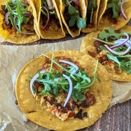 Tacos laying on a wood table